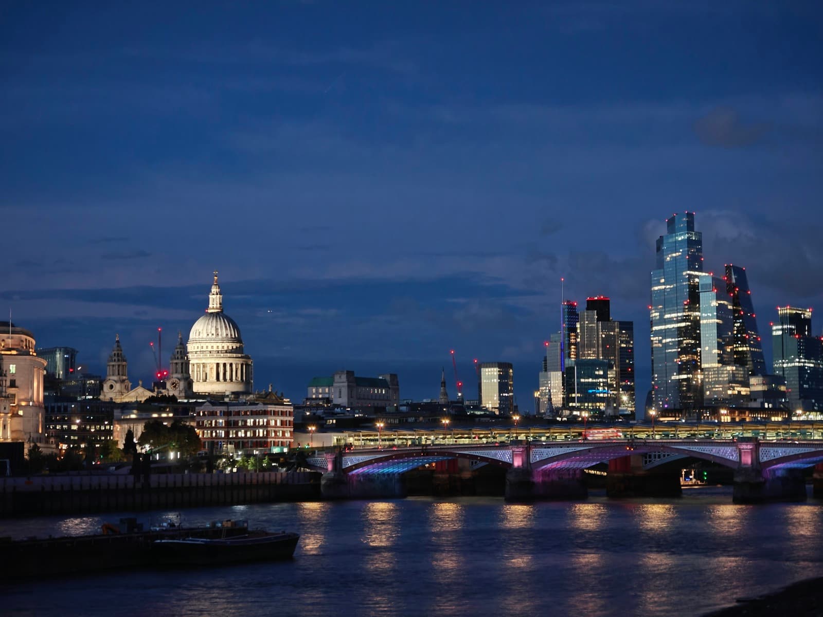 St Paul's Cathedral and the City of London skyline at dusk over the Thames